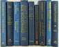 Blue books with gold  titles by the foot for decor